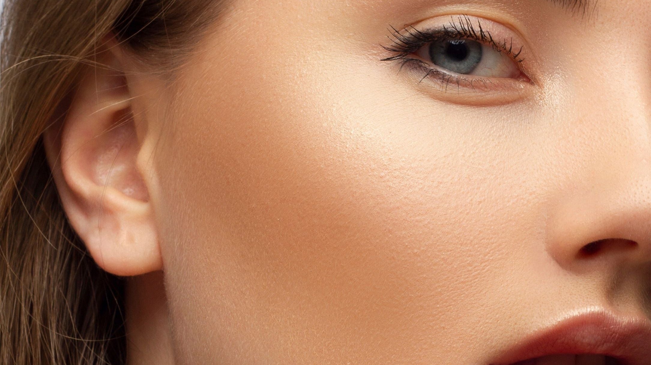 Close-up of a model wearing bronzer with a natural sun-kissed glow, demonstrating how to apply bronzer correctly.
