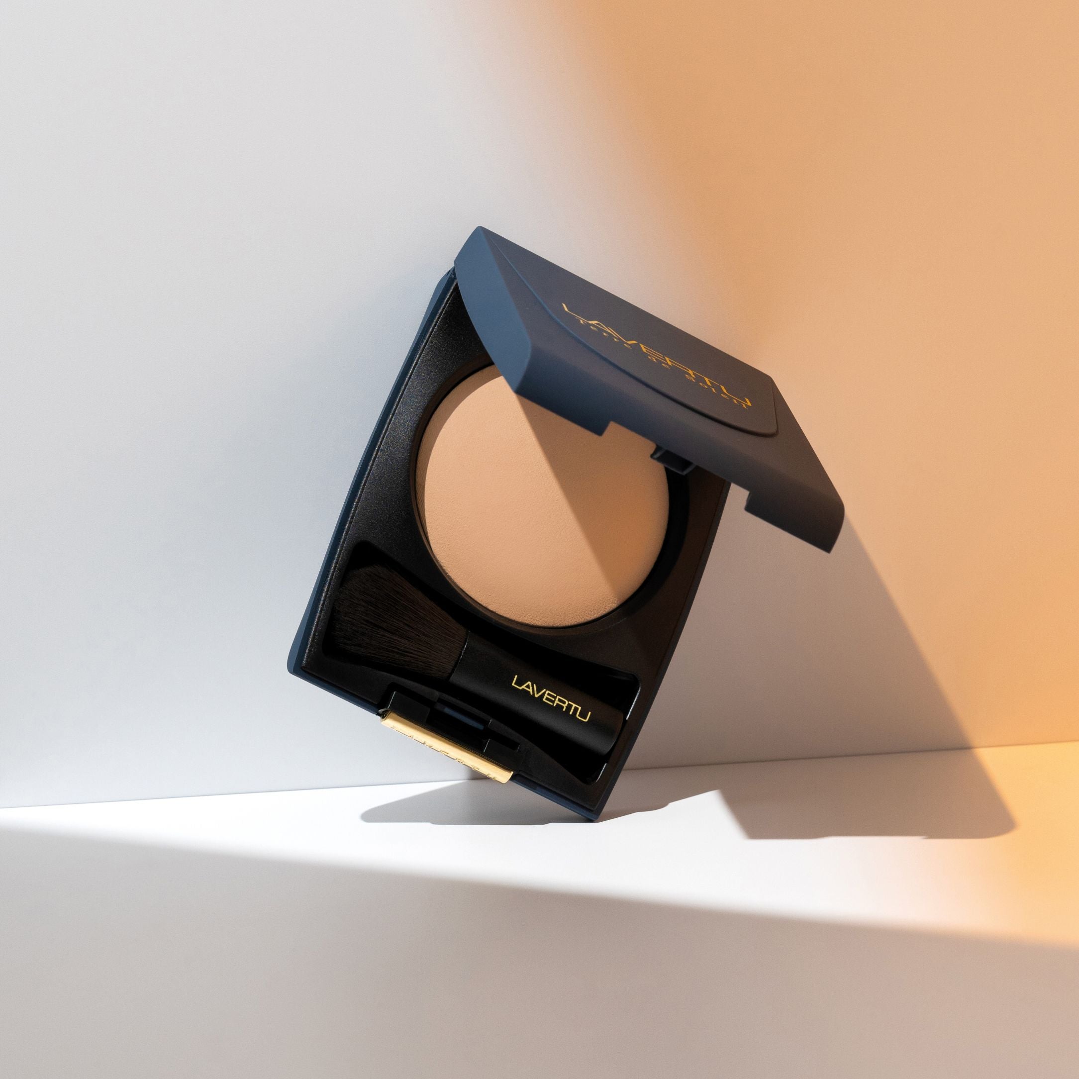 Lavertu Terre de Soleil baked bronzer 03 Light compact with warm light bronze tone and integrated brush.