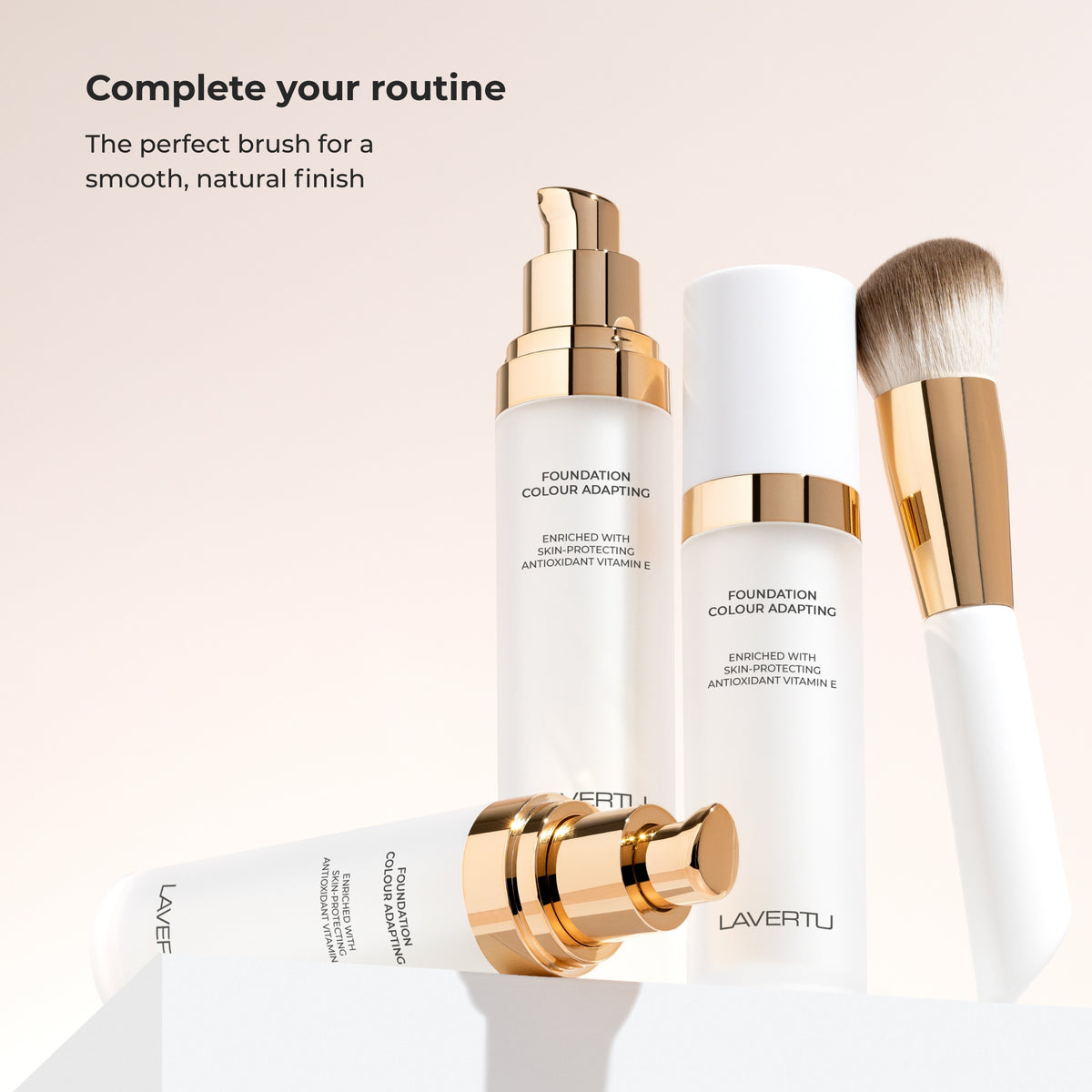 Lavertu Colour Adapting Foundation in white packaging with a gold pump, alongside the matching foundation brush.