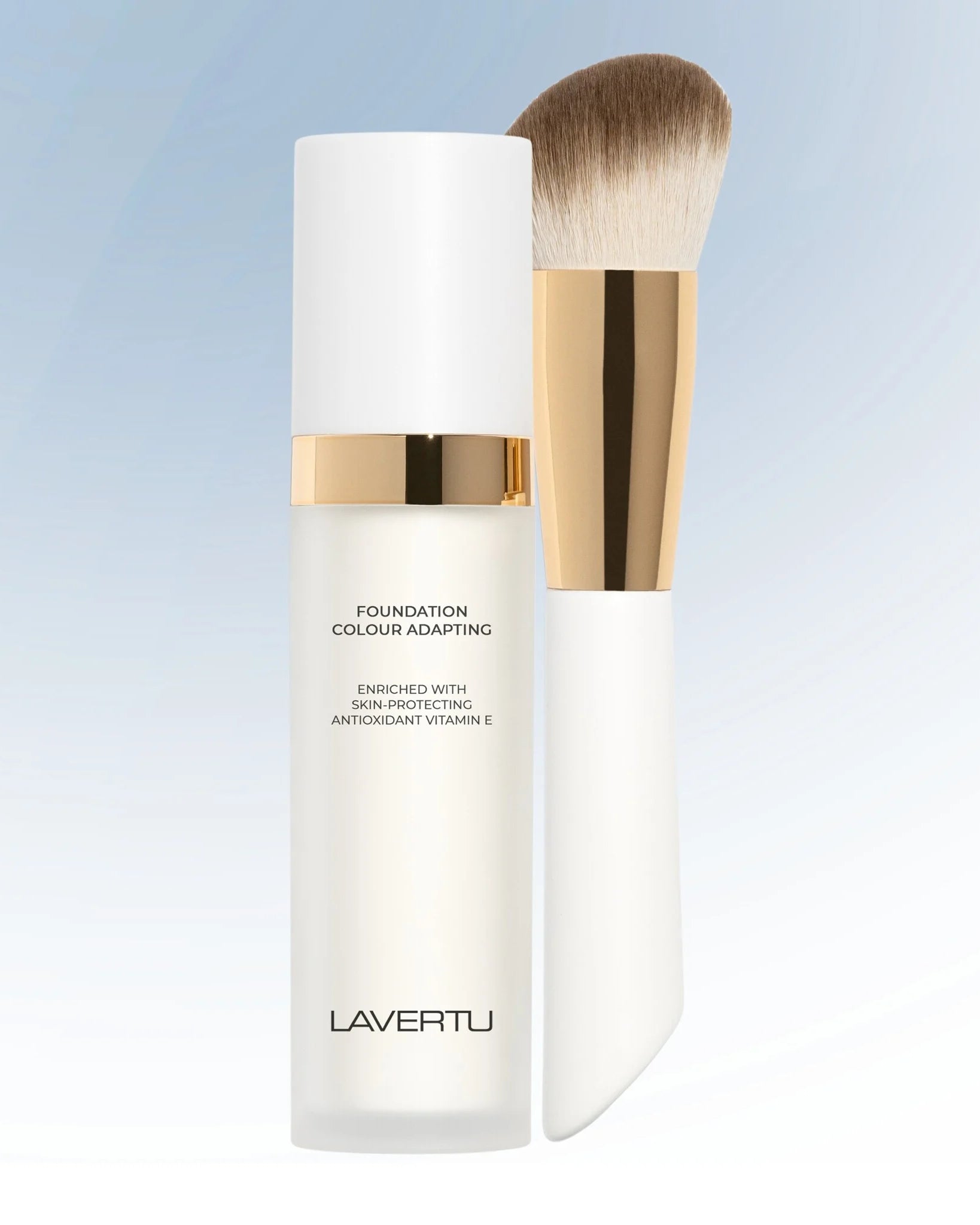 Lavertu Colour Adapting Foundation bottle with vegan makeup brush on light gradient background