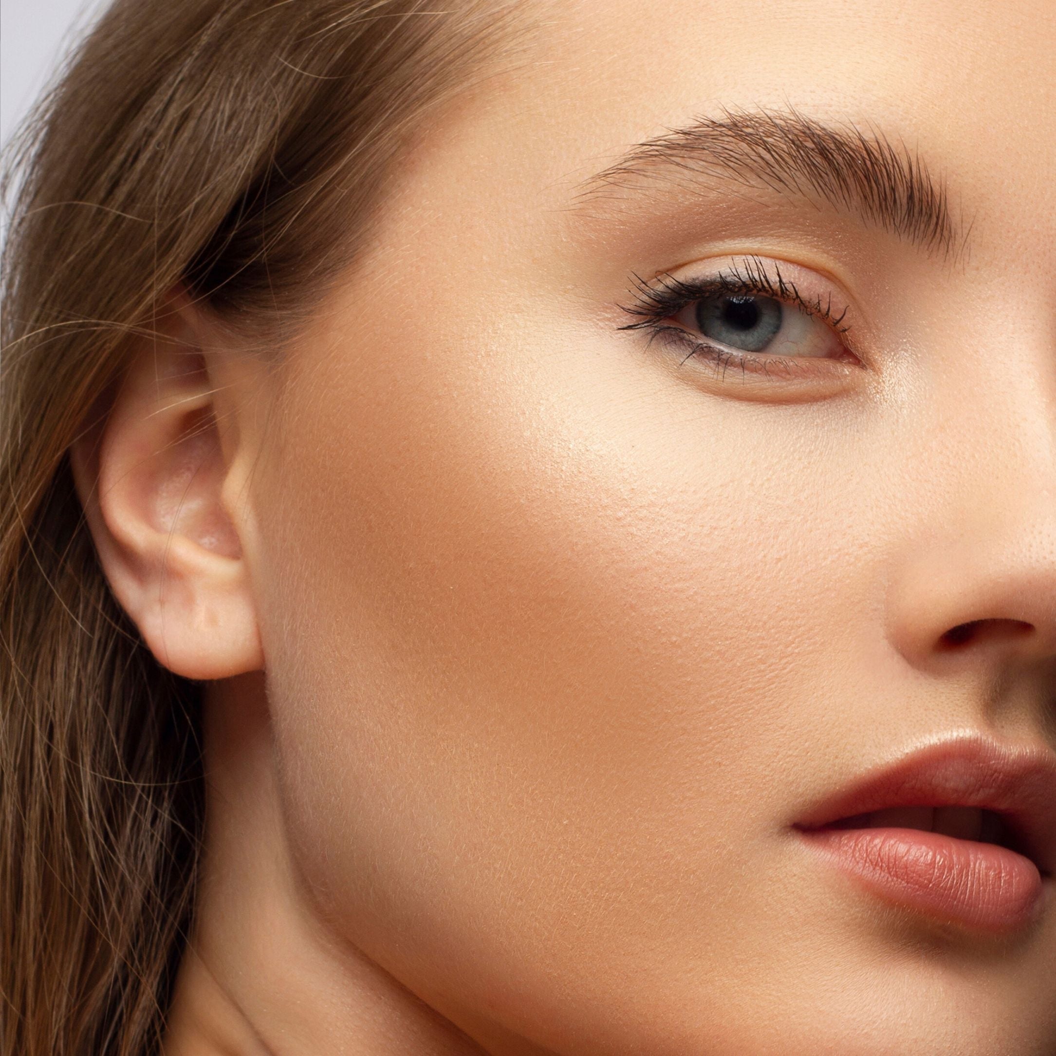 Close-up of a model wearing bronzer with a natural sun-kissed glow, demonstrating how to apply bronzer correctly.