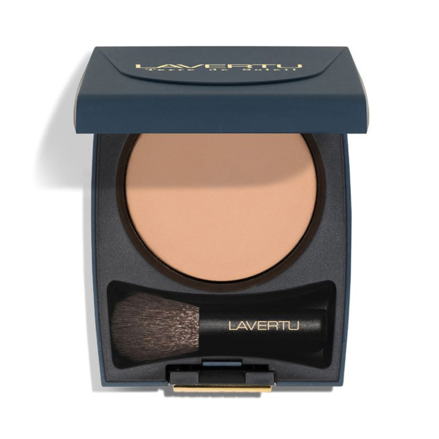 Lavertu powder compact with brush on a white background