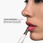 Model applying Lavertu Renewal Adaptive Lip Oil for a natural pink tint that reacts to the lips’ pH