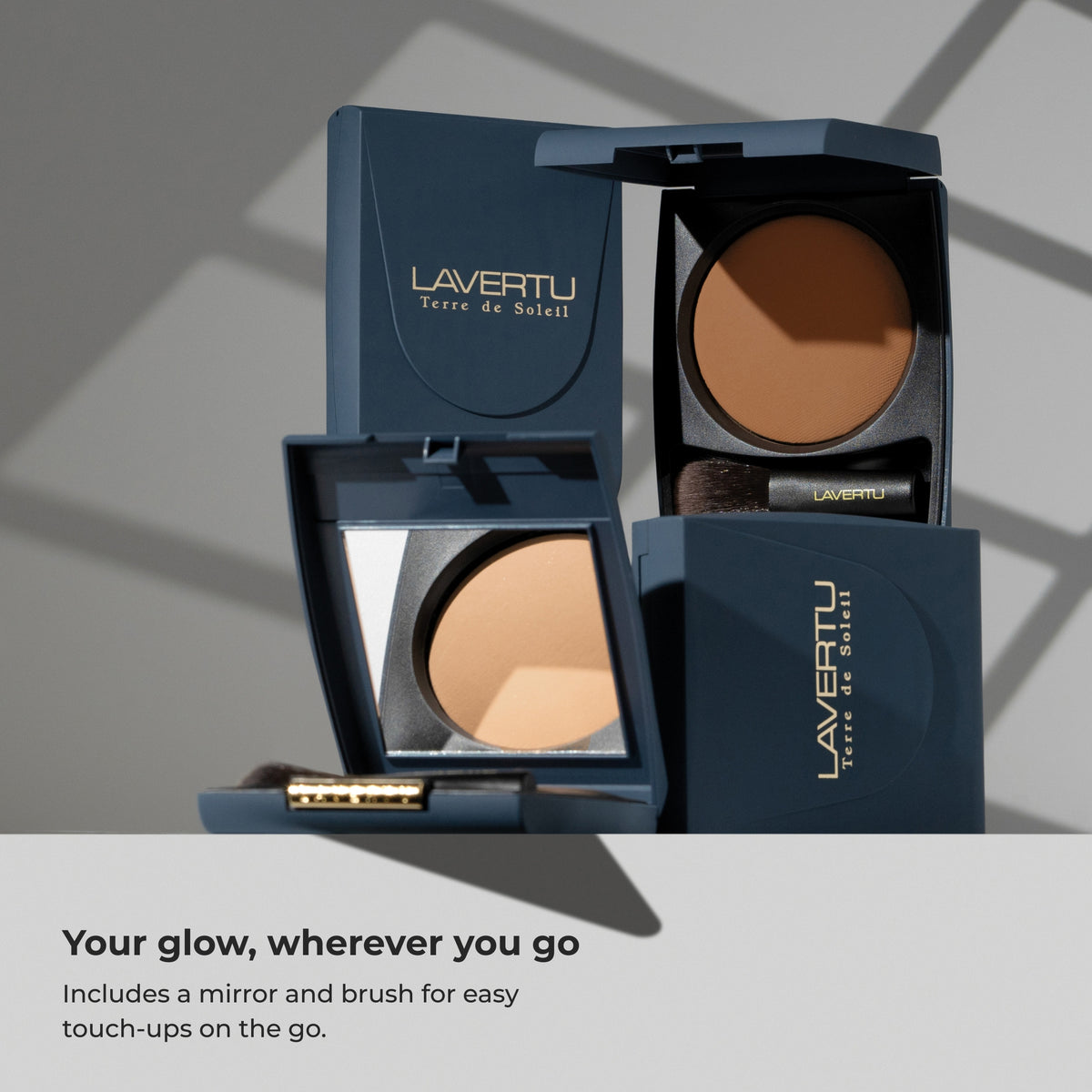 Lavertu Terre de Soleil Bronzer in navy blue compacts with built-in mirror and brush for touch-ups on the go