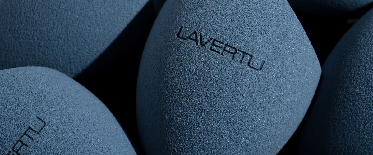 Blue textured makeup sponge with 'LAVERTU' branding on a dark background