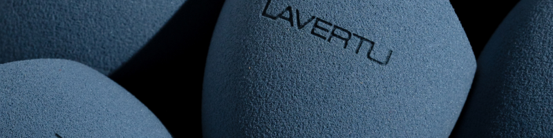 Blue textured makeup sponge with 'LAVERTU' branding on a dark background