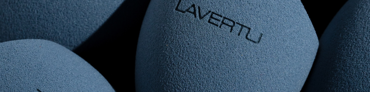 Blue textured makeup sponge with 'LAVERTU' branding on a dark background