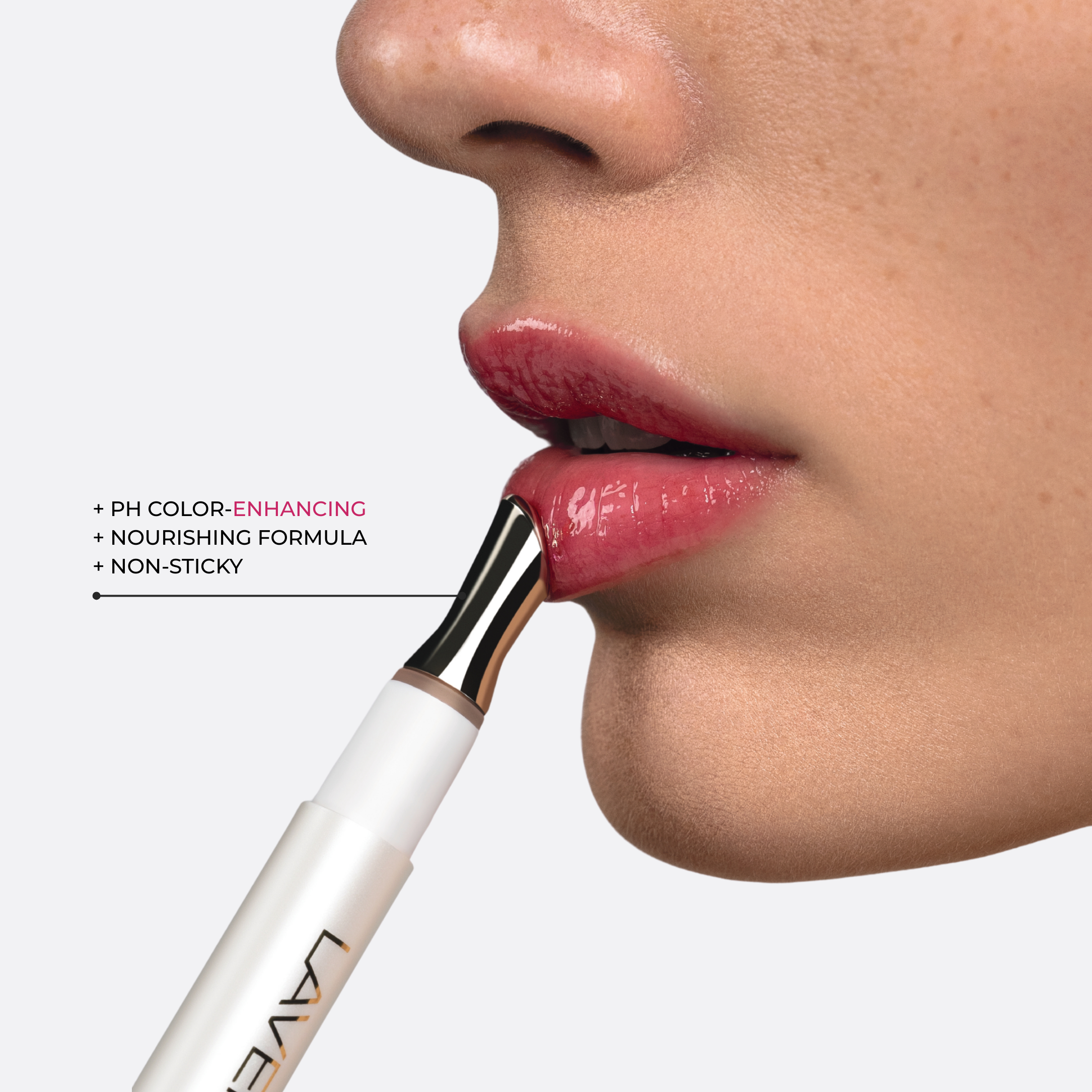 LAVERTU Renewal Adaptive Lip Oil applied to lips with gold applicator, showing natural pink glow.